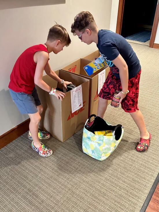 boys putting items into box