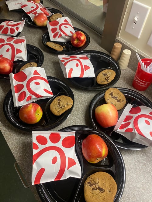 Verger Capital team members serve lunch to students at the Winston Salem Street School