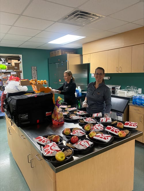 Verger Capital team members serve lunch to students at the Winston Salem Street School